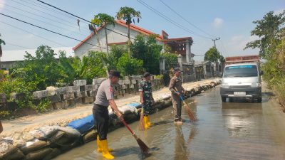 Pasca Banjir 4 Bulan, Polisi dan BPBD Bersihkan Lumut di Jalan Poros Jelakcatur