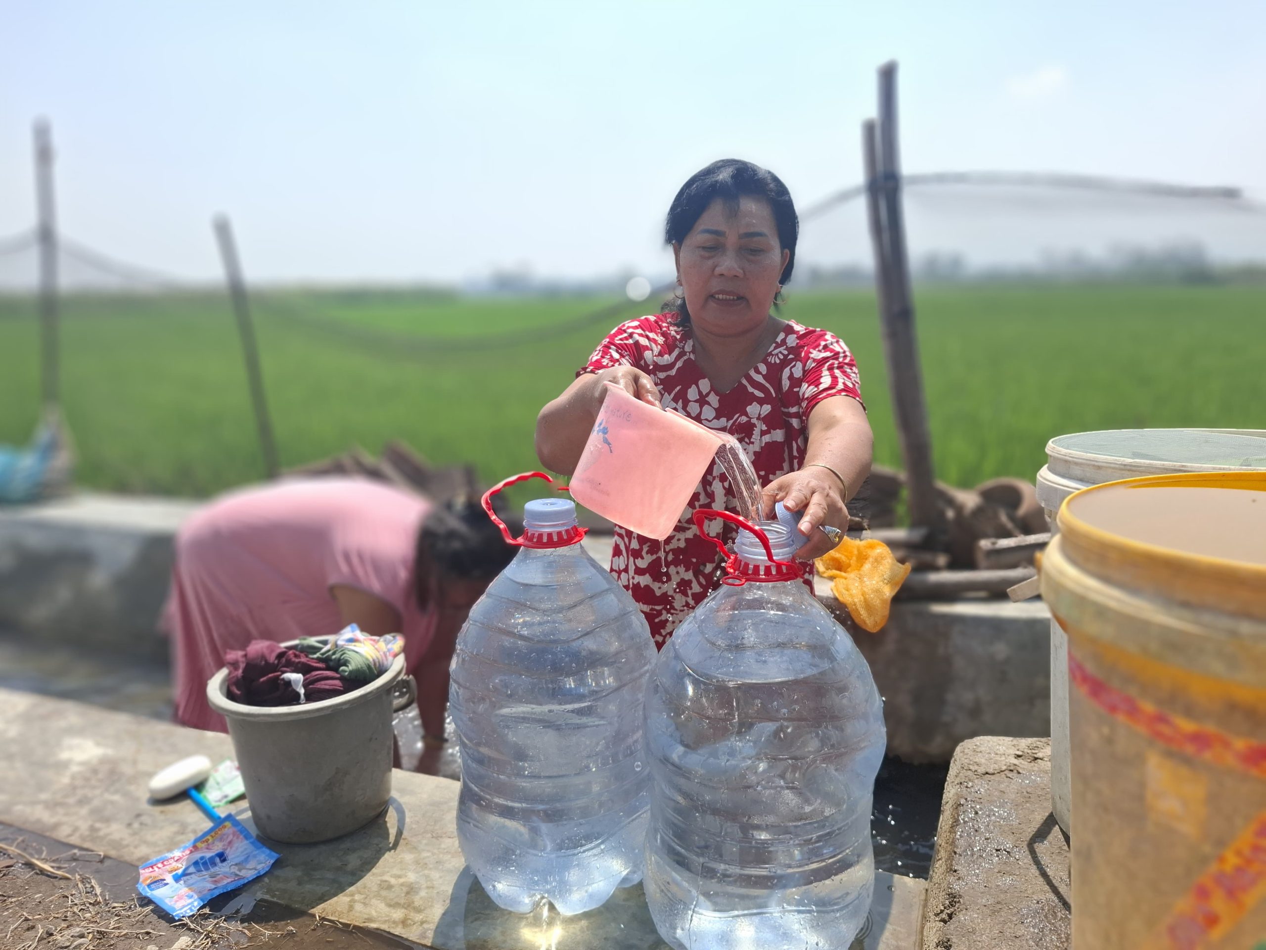 Pompa Irigasi Diduga Bikin Sumur Warga Mojowarno Kering, Ibu-Ibu Terpaksa Ambil Air di Saluran Sawah